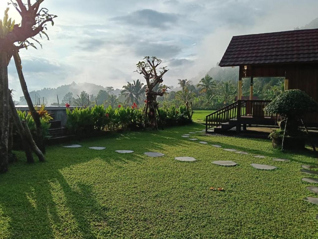 a garden with a pavilion and a grass yard at Uma Ayu Bali in Munduk