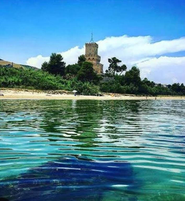 an island with a castle in the middle of the water at Playadeivo in Pineto