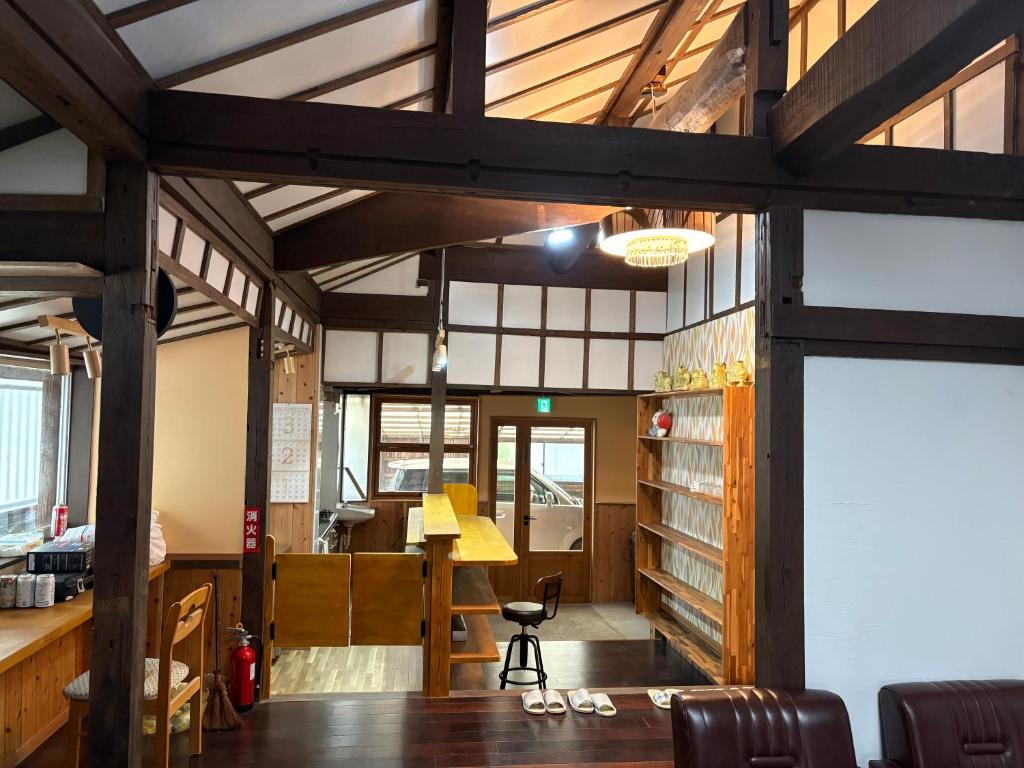 a room with a desk and a table in a building at 指宿古民家宿 in Ibusuki