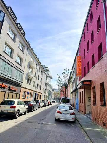a city street with cars parked on the street at Andefu Hotel am Kantpark in Duisburg