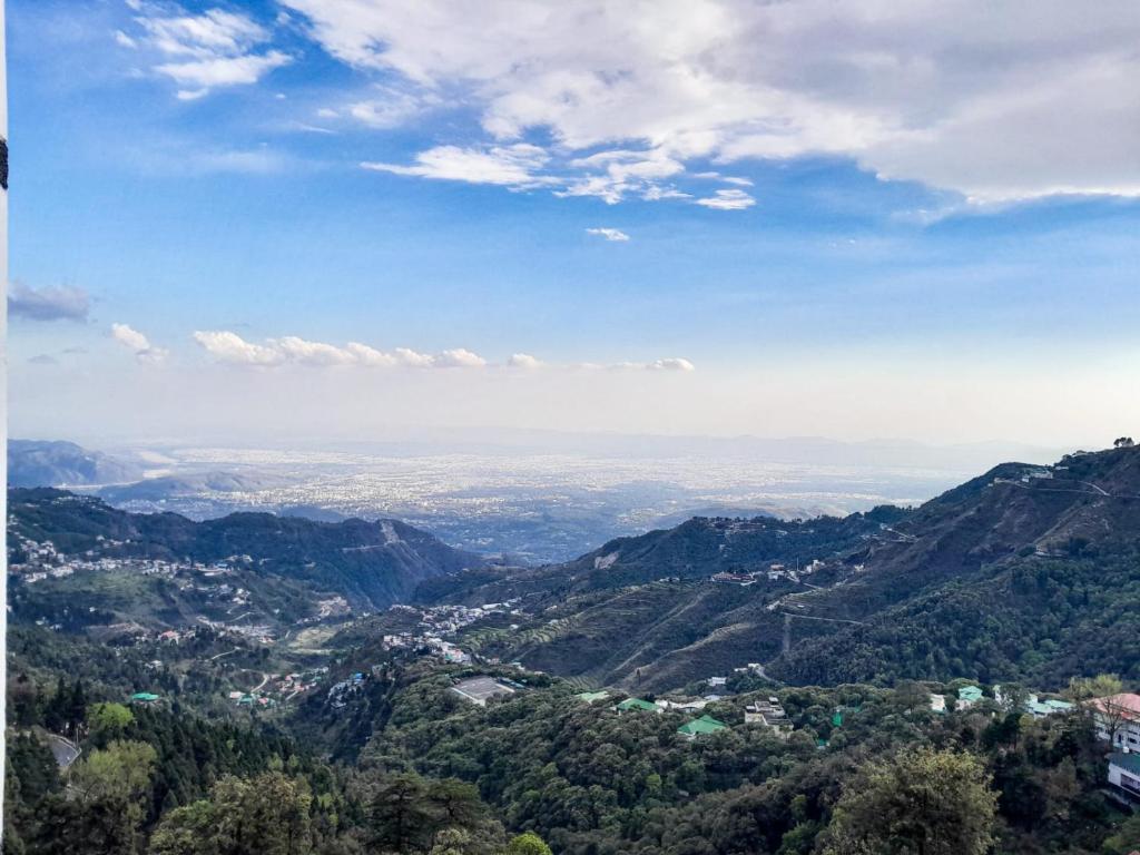 a view of a valley in the mountains at The Three Oaks Boutique Hotel in Mussoorie