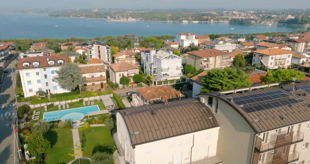 an aerial view of a city with buildings and a body of water at Homingarda Apartments, Pool & Garden, Near Lake Garda and Center in Peschiera del Garda