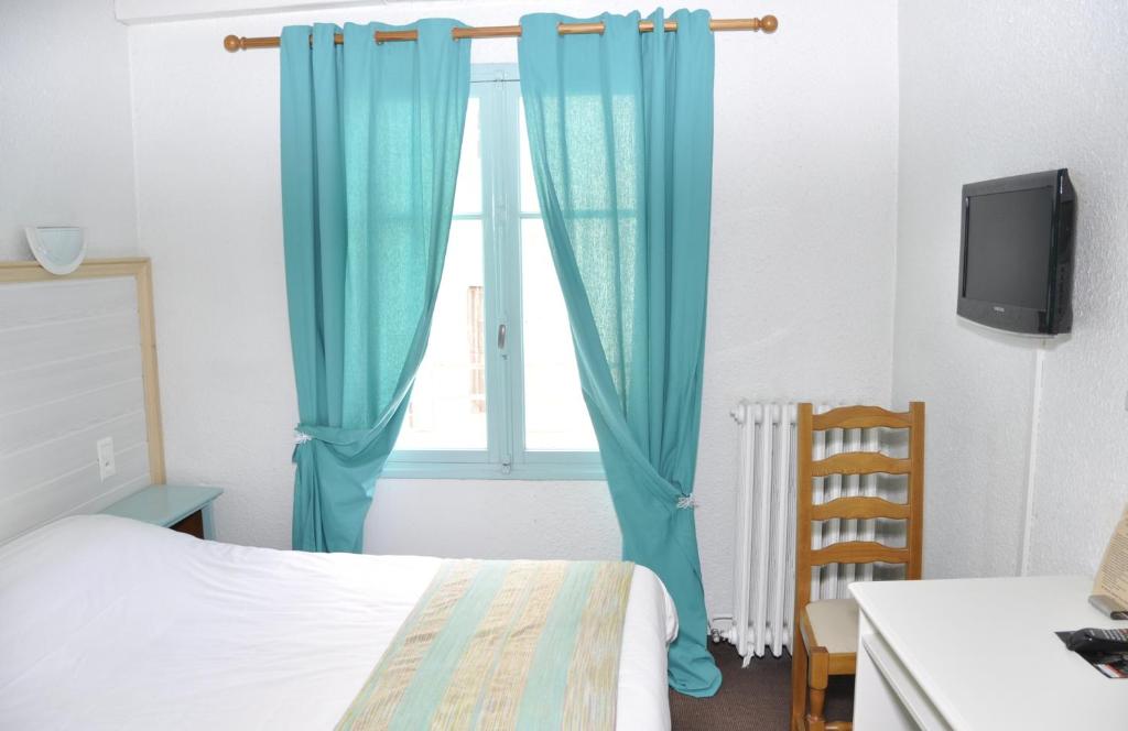 Postel nebo postele na pokoji v ubytování Citotel Hôtel Cesar