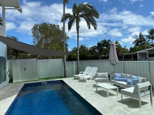 a patio with a swimming pool with chairs and avisor at Flip flops in Horseshoe Bay