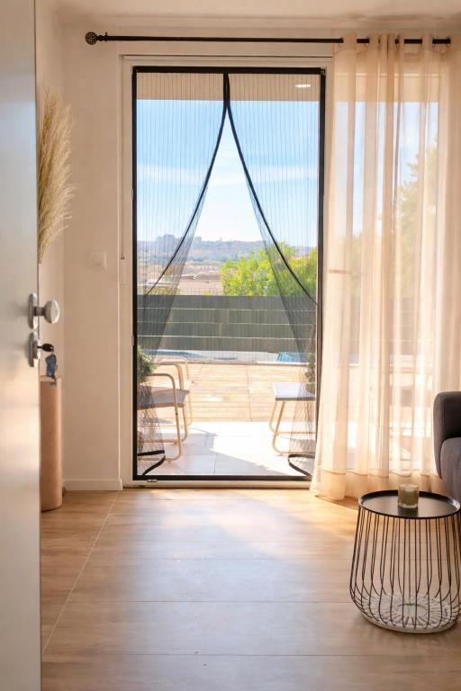 a living room with a door open to a patio at Nashi Garden Apartment Split with City View & Parking in Solin