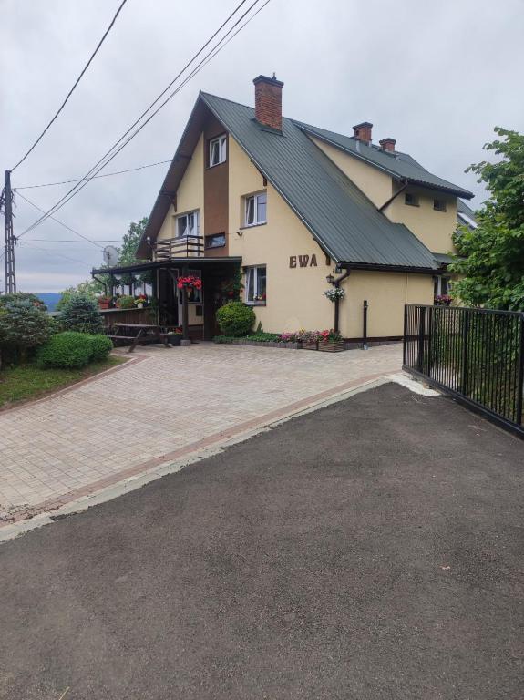 a large house with a driveway in front of it at DG EWA w Polańczyku in Polańczyk