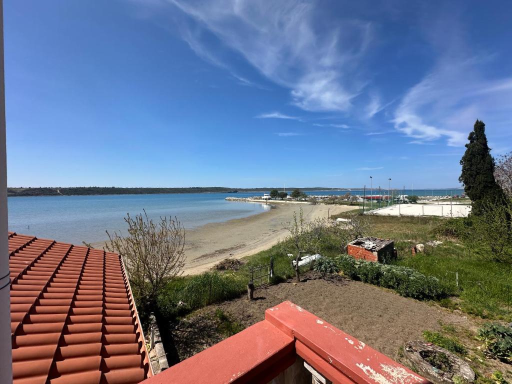a view of a beach from the roof of a house at Villa M, App 4 - 6 persons direct on the seaside, 1st floor in Ljubač