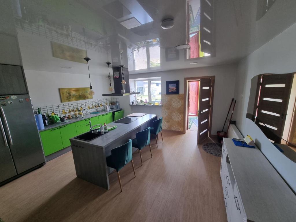 a kitchen with green cabinets and a counter top at Natural oasis in Vilainiai