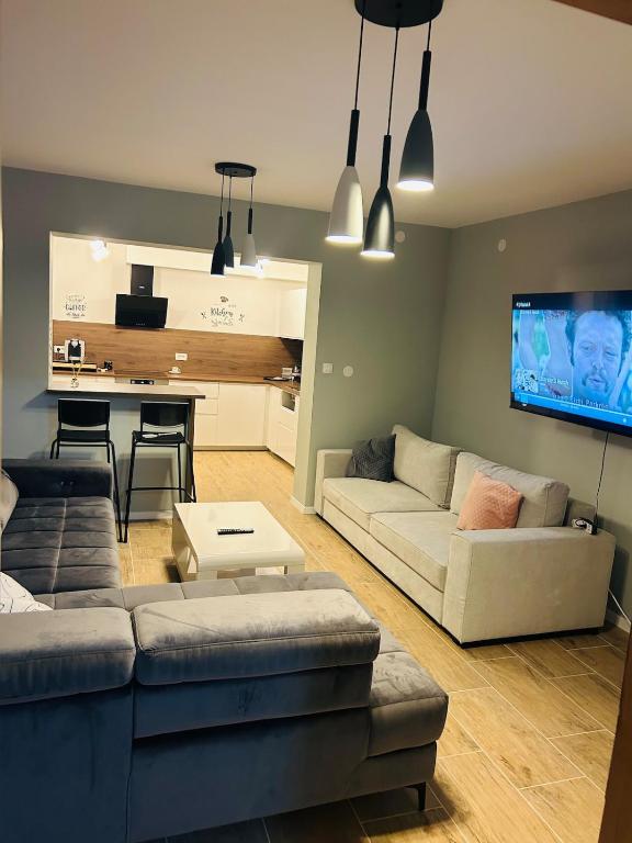 a living room with a couch and a table at AS Apartment Free Parking and Peaceful Nature near Ljubljana in Škofljica