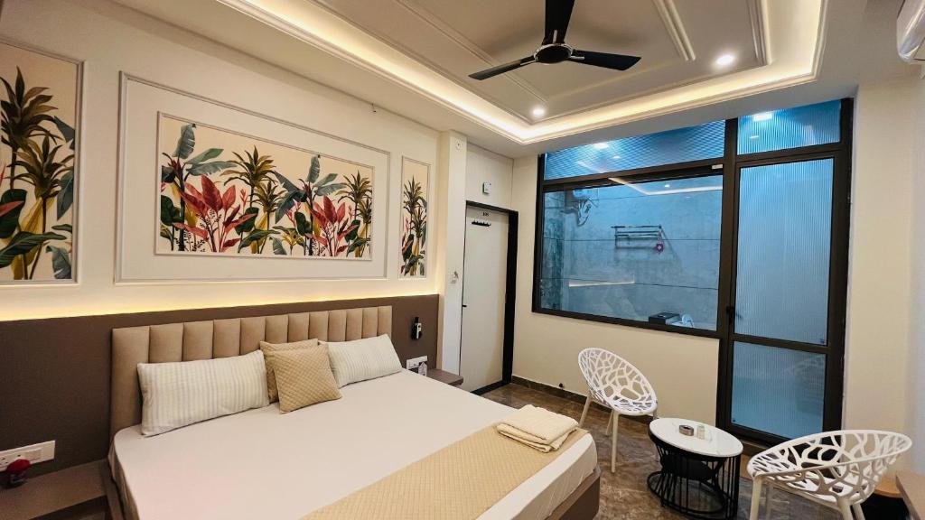 a bedroom with a bed and a window at Hotel Neelkanth Prime Retreat, Kekri in Kekri