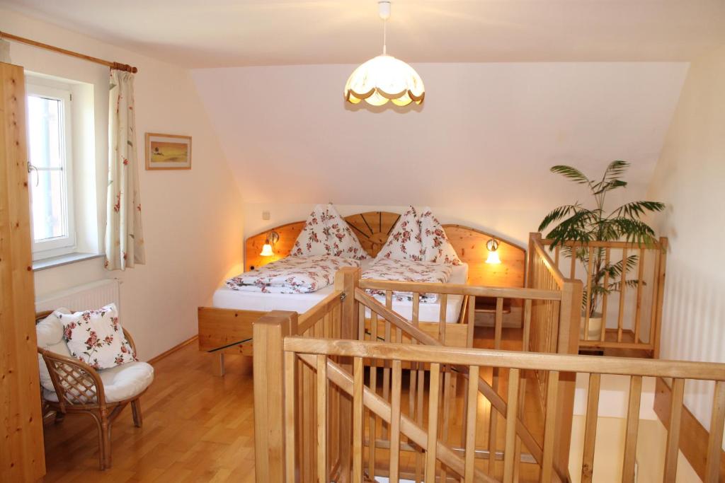 a bedroom with a bed and a chair at Landhaus Bender Ferienwohnung mit Terrasse und Garten in Straden