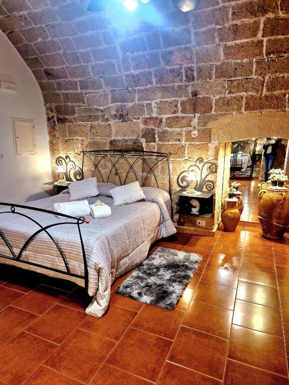 a bedroom with a bed and a stone wall at casa Carlos in Bari Palese