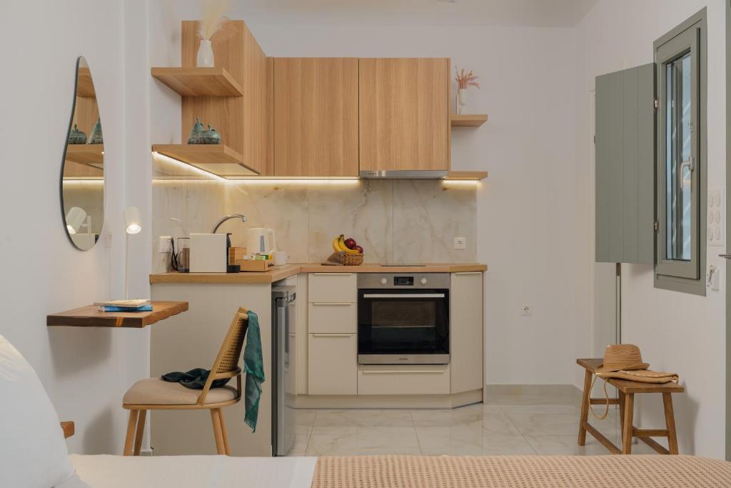 a kitchen with wooden cabinets and a stove top oven at Luaz Naxian living in Naxos Chora