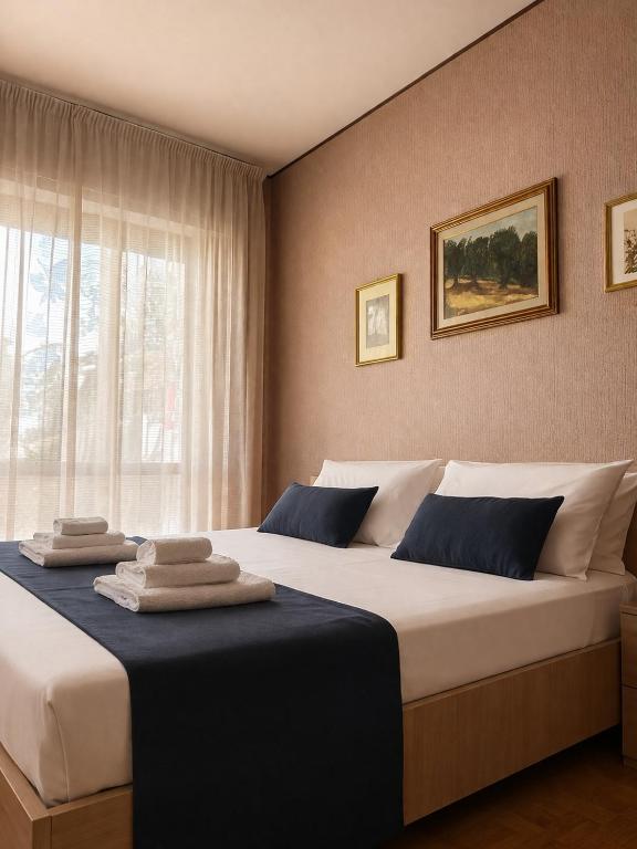 a bedroom with two beds with towels on them at ELIOS Grand Apartment in Tropea