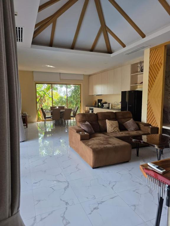 a large living room with a couch and a table at Golden Villa in Ko Phangan