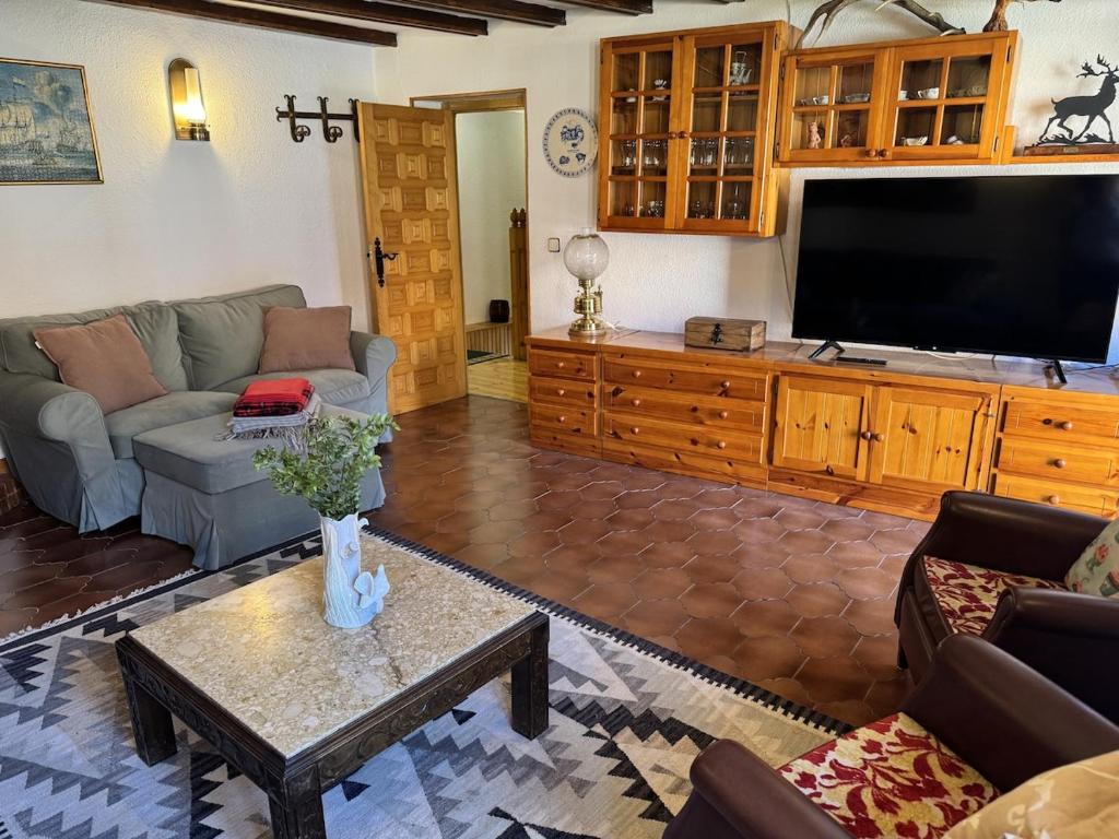 a living room with a large flat screen tv at Casa El Carril Vinuesa in Vinuesa