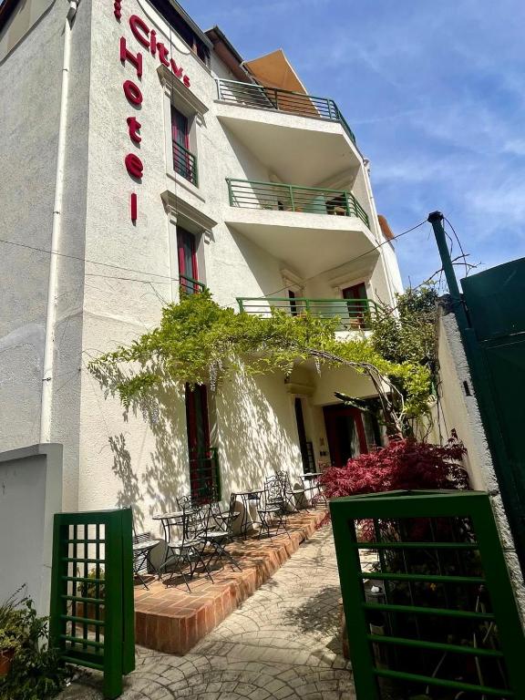 a white building with a sign on the side of it at City 5 Hotel in Tirana