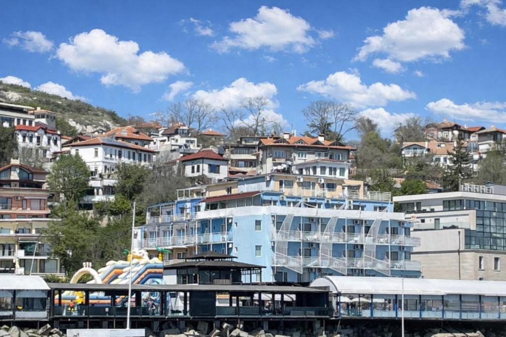 a group of buildings in a city with a train at Lotos Hotel in Balchik