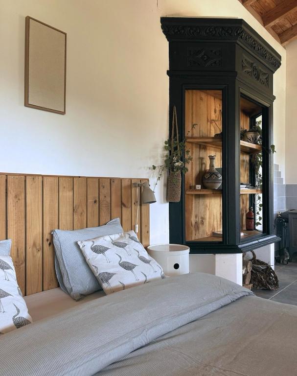 a bedroom with a bed and a black cabinet at San Bartolome Etxea 1 in Ea