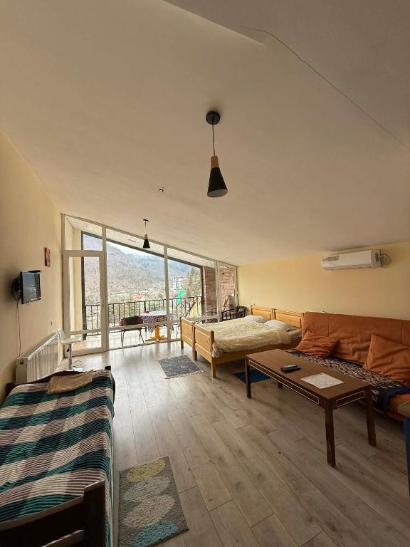 a living room with a couch and a table at ksenia apartment in Borjomi