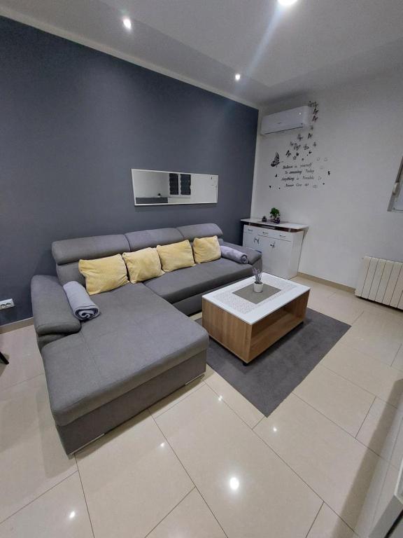 a living room with a couch and a coffee table at Apartment Alex in Rijeka
