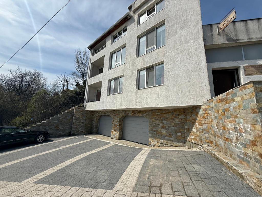 a building with a parking lot in front of it at Villa Climate Guest House in Varna City