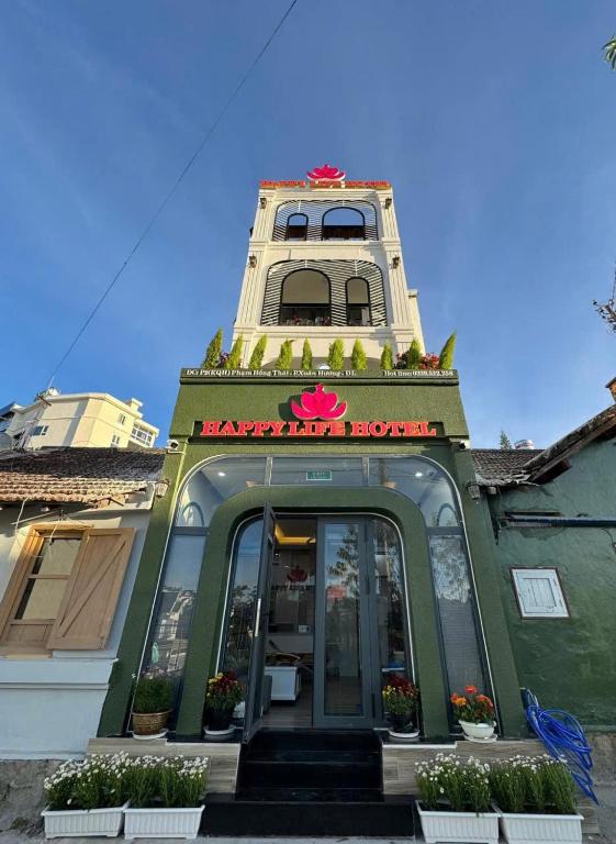 a building with a clock tower on top of it at Happy Life Hotel DaLat in Da Lat