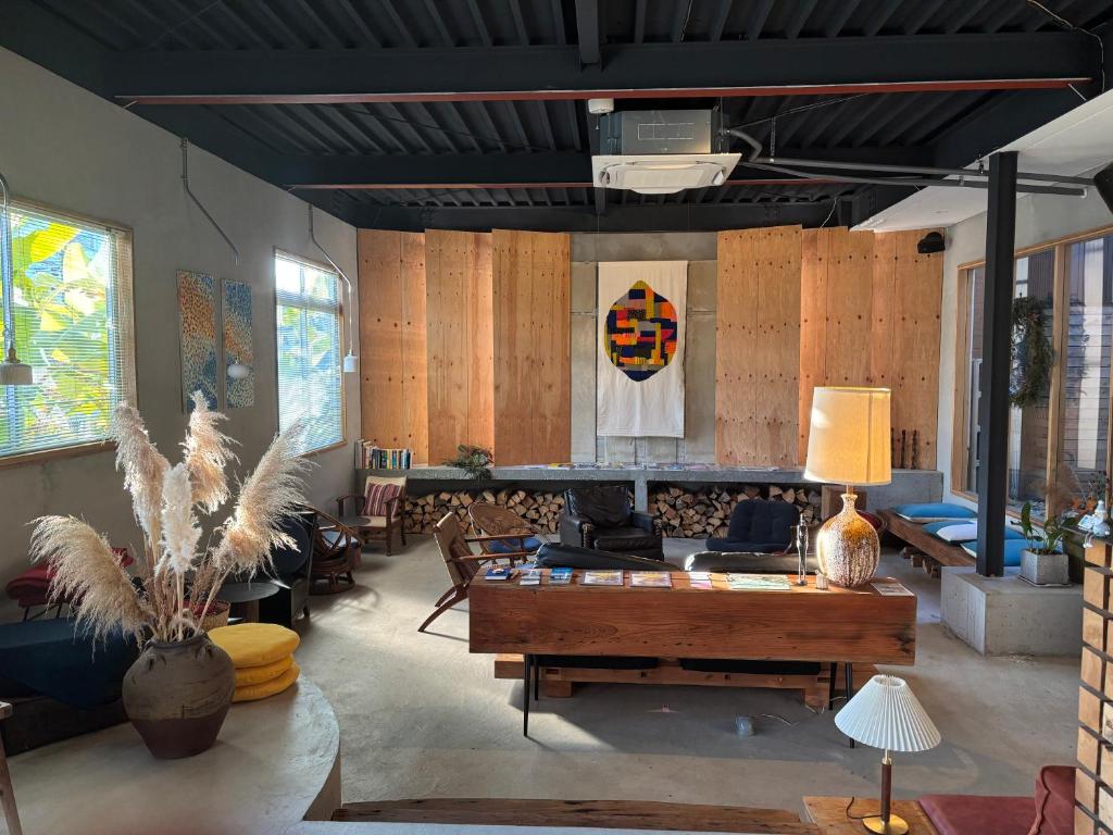 a living room with a couch and a table at Lemonsea Onomichi in Onomichi