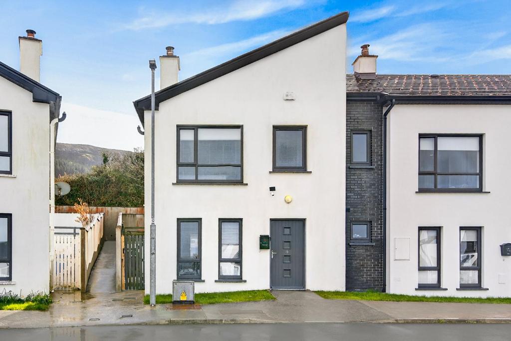 an exterior view of a white house with black windows at Cnoc Na RI in Strandhill