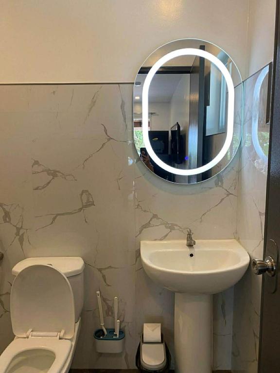 a bathroom with a sink and a toilet and a mirror at Peaceful Turtle Camp in San Francisco