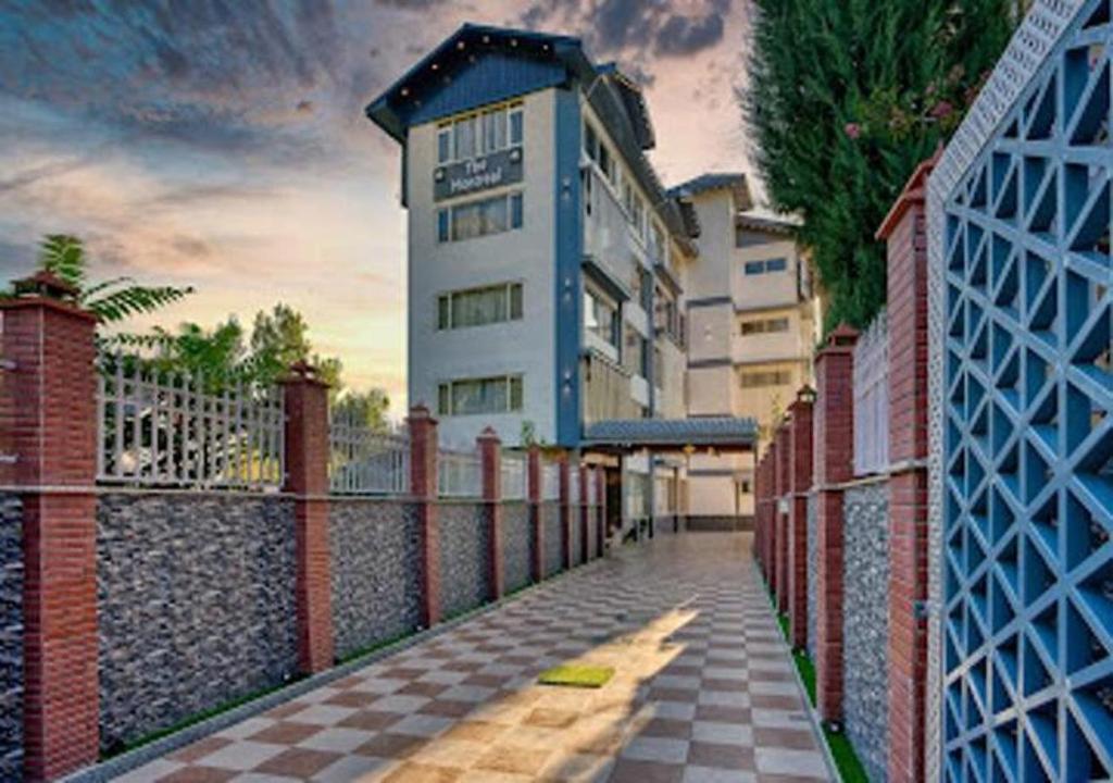 a building that is next to a fence at The Montreal Srinagar A Unit Of Montreal Group in Srinagar