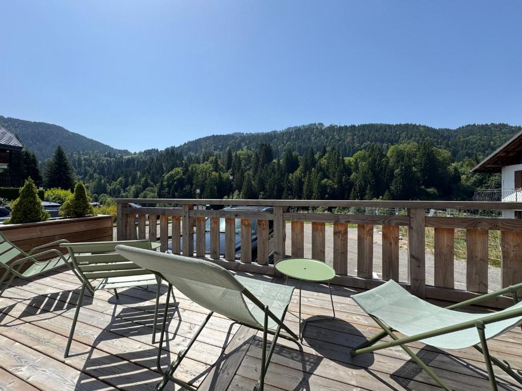 a group of chairs sitting on a deck with a view at Rosalia Alpina 3 Chambres in Morzine