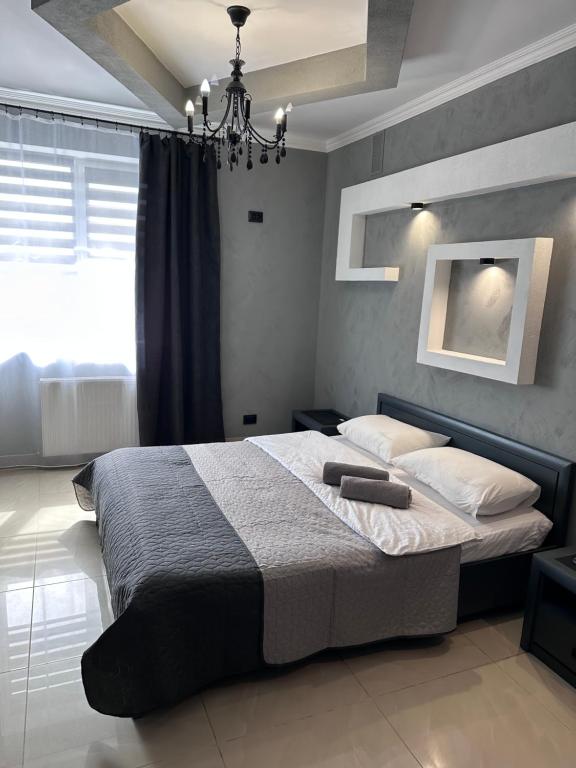 a bedroom with a large bed with a chandelier at Avto Spa in Khmelnytskyi