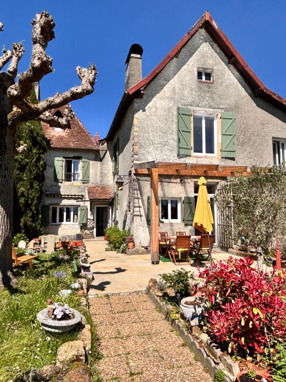 an exterior view of a house with a patio at Chambres d'Hôtes Colibri in Arthez-de-Béarn