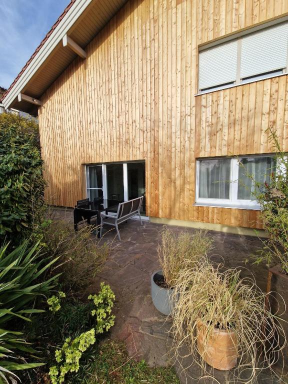 a patio in front of a wooden building at Ferienwohnung Zürcher in Chieming