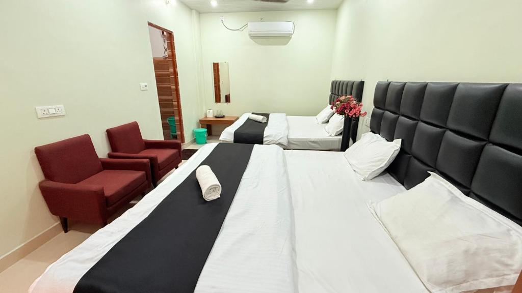 a room with a bed and a couch and a chair at Hotel Blessing Inn & Restaurant in Prayagraj