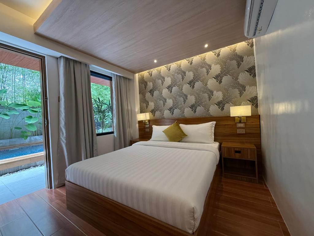 a bedroom with a large white bed and a window at Choox Villa Hotel in Koronadal