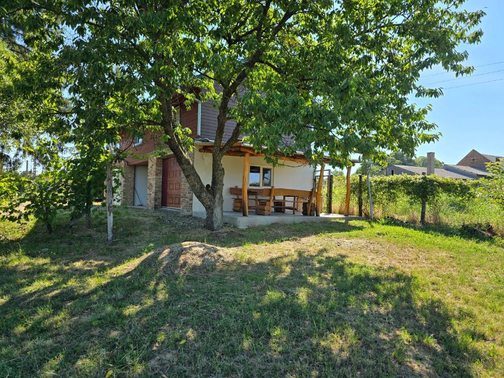 a house with a tree in the yard at Mara Ház in Lengyel