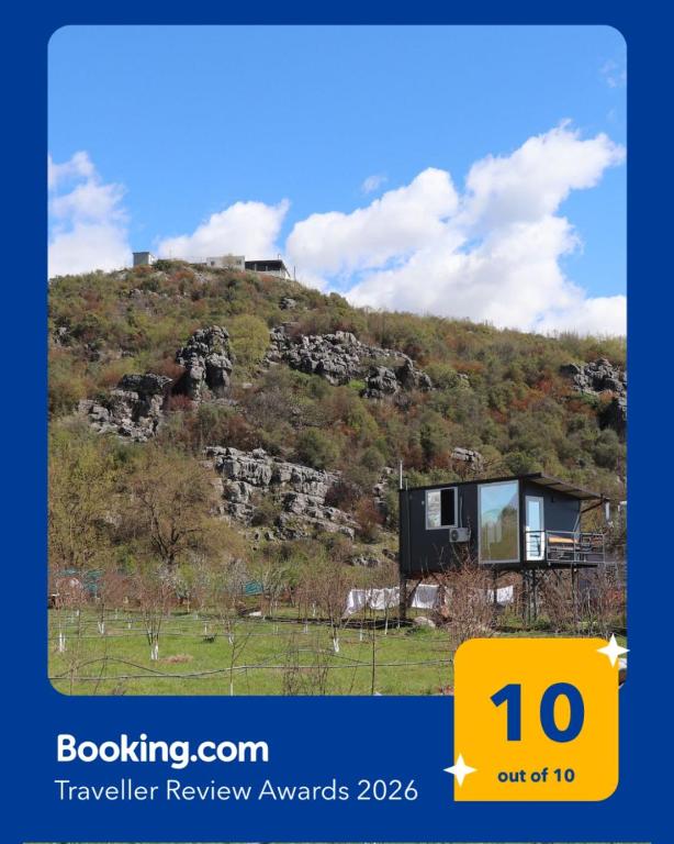 a house on the side of a hill at Orchard Guard Tower in Ivanaj