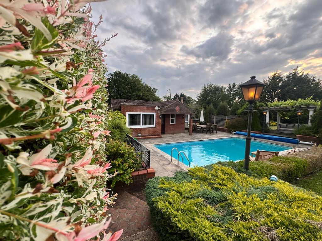 a house with a swimming pool in a yard at The pool house in Bedford