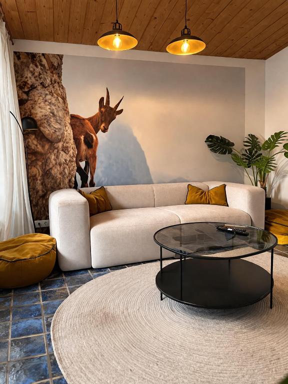 a living room with a couch and a table at Ferienwohnung Steinbock mit Bergblick in Bayrischzell