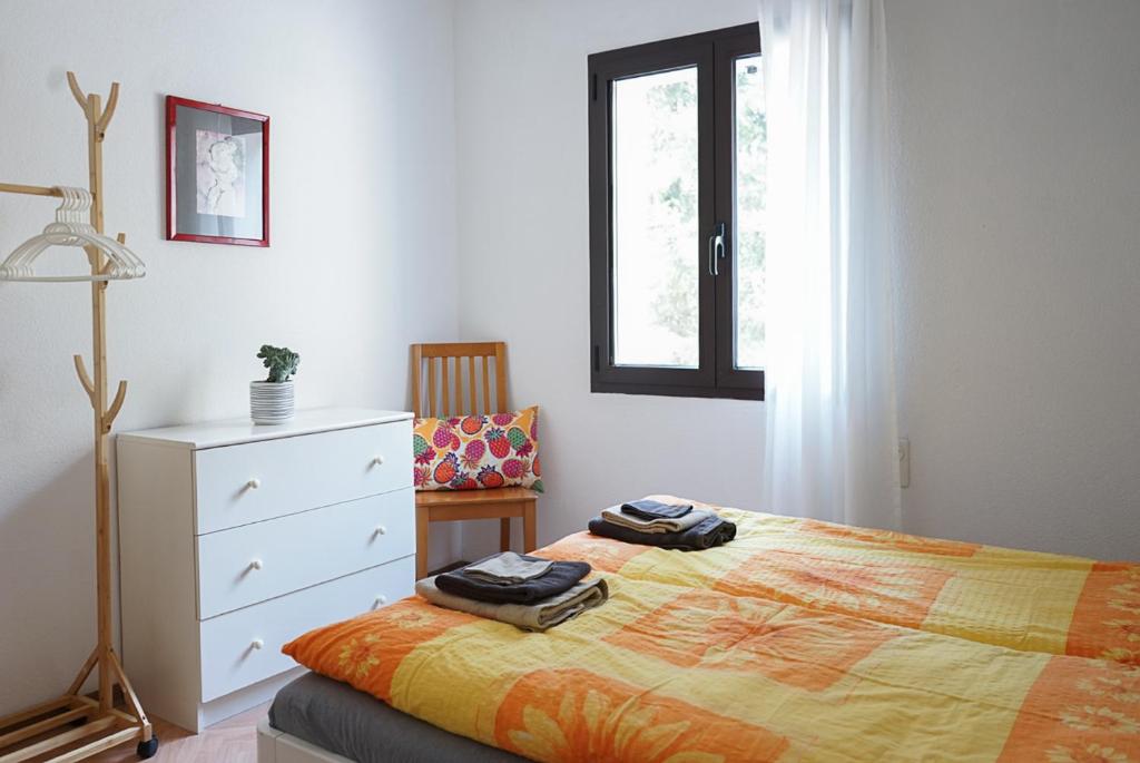 a bedroom with a bed and a dresser and a window at Ristorante Locanda Zott in Valle Onsernone in Vergeletto