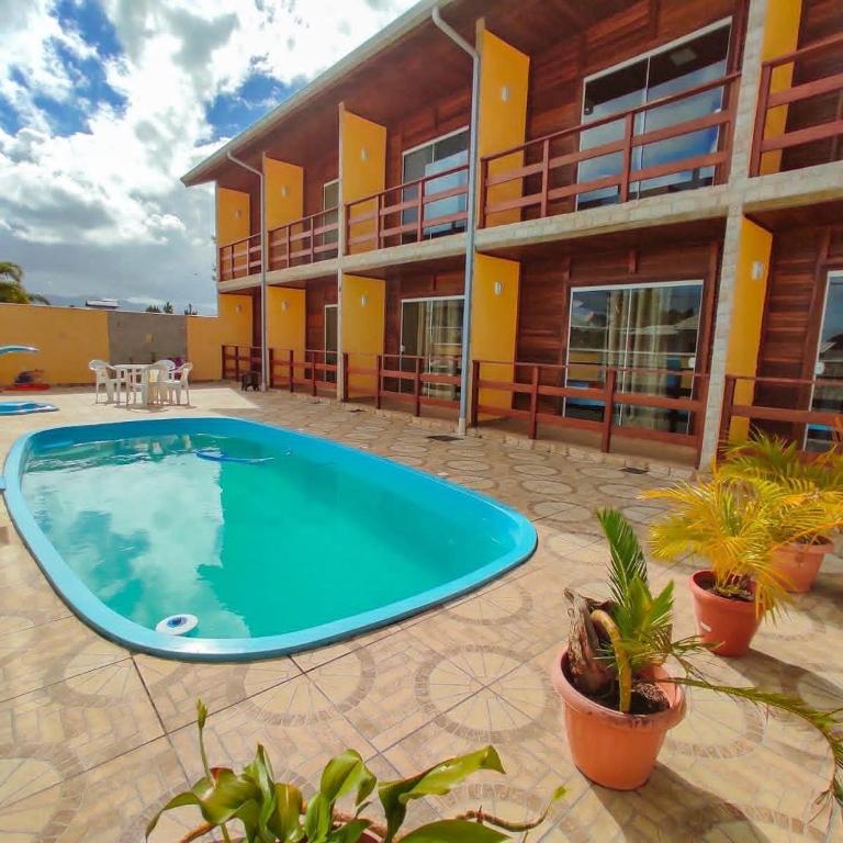 a large swimming pool in front of a building at Hotel 5km da Guarda do Embaú in Palhoça
