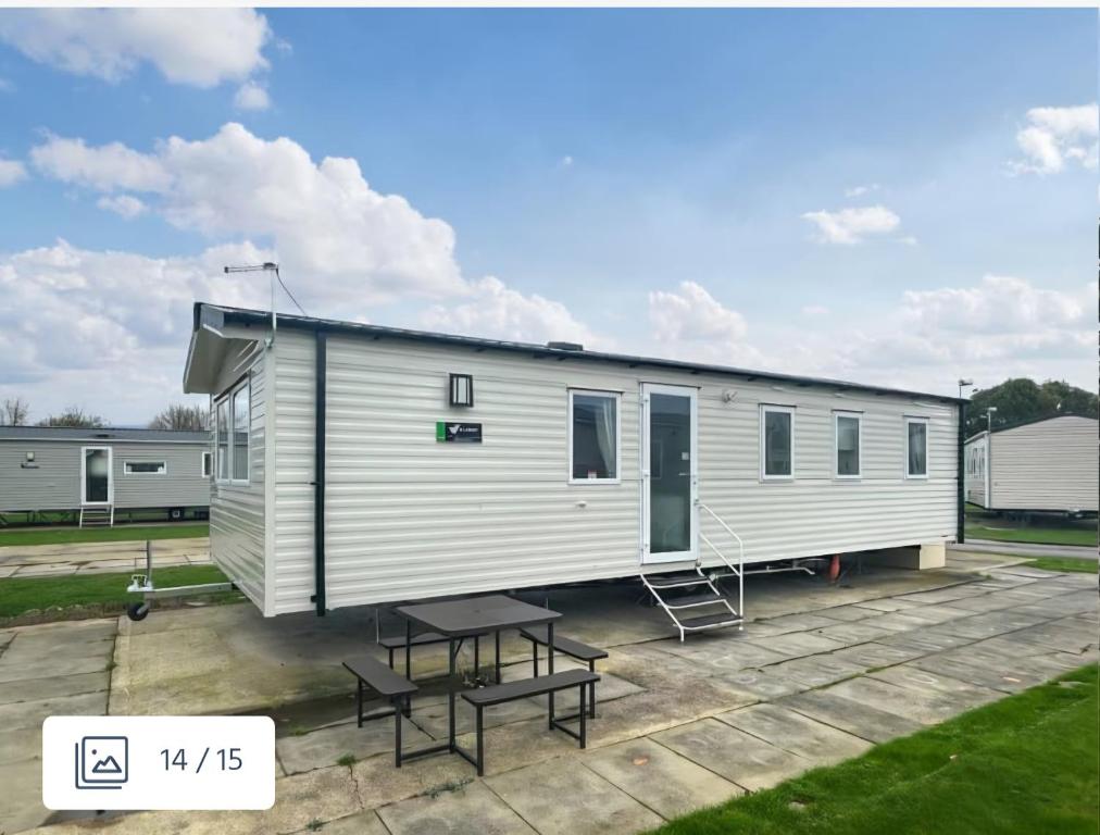 a large white trailer with a picnic table and a bench at D&A Southview getaway in Skegness