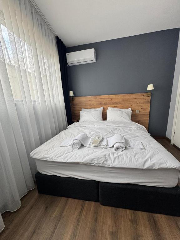 a bedroom with a bed with two towels on it at New Yasamkent Atakoru Double Suite in Alacaatlı
