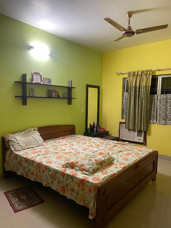 a bedroom with a bed in a room with green walls at Abode of Peace in Esperance
