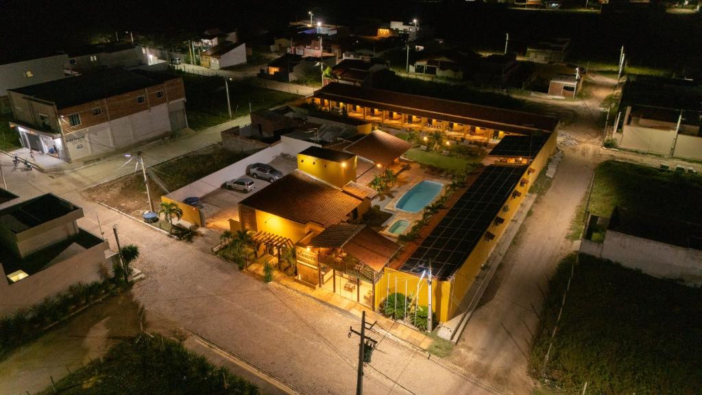 an overhead view of a large yellow building with a pool at Pousada pôr do sol in Riachuelo