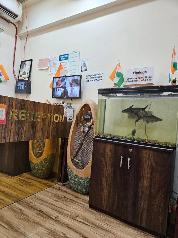 a room with a aquarium and a fish in it at hotel orange palace in Surat