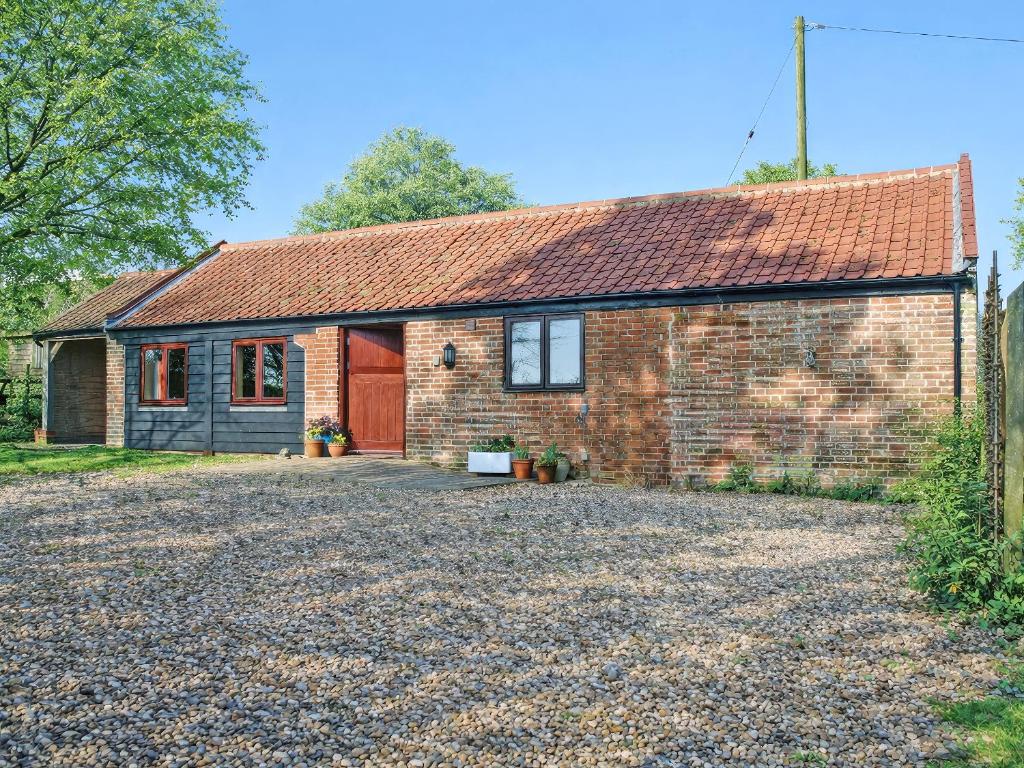 a brick house with a driveway in front of it at The Barn in Cantley