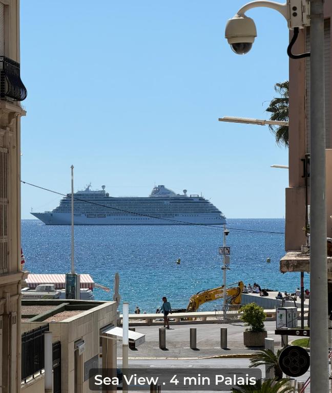 a cruise ship in the water with a beach at Sea View 2BR 2BA - 4 min Palais - Ideal Cannes Film Festival Stay in Cannes